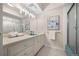 Bright bathroom featuring blue sink, tiled floors, and shower at 3942 E Evans Ave, Denver, CO 80210
