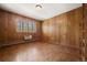 Cozy bedroom with wood paneled walls and hardwood parquet flooring at 3942 E Evans Ave, Denver, CO 80210