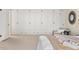 Bedroom featuring built-in wardrobes and a cozy seating area at 3942 E Evans Ave, Denver, CO 80210