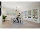 Bright dining room featuring white trim, white french doors, and a round table at 3942 E Evans Ave, Denver, CO 80210