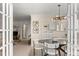 An open dining room sits adjacent to the living room with a modern chandelier at 3942 E Evans Ave, Denver, CO 80210