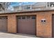 Garage featuring brickwork and multiple garage doors at 3942 E Evans Ave, Denver, CO 80210