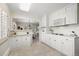Bright kitchen features recessed lighting, tiled floor and view into breakfast nook and dining room at 3942 E Evans Ave, Denver, CO 80210