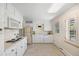Traditional-style white kitchen with ample counter space and natural lighting at 3942 E Evans Ave, Denver, CO 80210