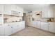 Spacious kitchen with white cabinets, and modern appliances at 3942 E Evans Ave, Denver, CO 80210