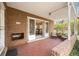 Covered brick patio with seating, overlooking a dining area through open doors at 3942 E Evans Ave, Denver, CO 80210