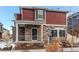 This exterior elevation features a covered porch with stone accents and mixed siding at 4048 N Quatar Ct, Aurora, CO 80019