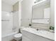 Clean bathroom with a vanity, marble countertop, mirror, bathtub, and a shower head at 12885 W Alameda Dr, Lakewood, CO 80228
