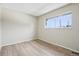 Bright bedroom with neutral walls, hard wood flooring, and a large window at 12885 W Alameda Dr, Lakewood, CO 80228