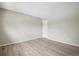 Empty bedroom featuring a neutral wall color, light wood floors, and a door to the hallway at 12885 W Alameda Dr, Lakewood, CO 80228