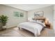 Beautifully staged bedroom featuring a large window, soft rug, and stylish decor at 12885 W Alameda Dr, Lakewood, CO 80228