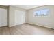 Well-lit bedroom with ample closet space and a large window for natural light at 12885 W Alameda Dr, Lakewood, CO 80228
