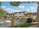 Exterior view of a multi-Gathering home with manicured lawns and a black metal fence surrounding a pool area at 12885 W Alameda Dr, Lakewood, CO 80228