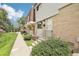 Charming townhome with brick and siding, showcasing front yard landscaping and pedestrian walkway at 12885 W Alameda Dr, Lakewood, CO 80228