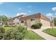 Townhomes featuring lush green lawns, trees, brick accents, and sidewalks at 12885 W Alameda Dr, Lakewood, CO 80228