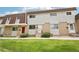 Exterior of townhomes featuring brick, siding, steps to the front door, and a green lawn at 12885 W Alameda Dr, Lakewood, CO 80228