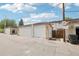 Back of home featuring 3 garages and individual access, under a sunny sky at 12885 W Alameda Dr, Lakewood, CO 80228