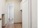 Bright hallway with wood floors, closet, and entryway into a light-filled room at 12885 W Alameda Dr, Lakewood, CO 80228