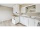 Spacious kitchen featuring bright white cabinetry, modern appliances, and hardwood floors at 12885 W Alameda Dr, Lakewood, CO 80228