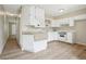 Well-lit kitchen featuring white cabinets, modern appliances, and a functional layout at 12885 W Alameda Dr, Lakewood, CO 80228