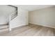 Bright living room featuring hardwood floors, a staircase, and a neutral color palette at 12885 W Alameda Dr, Lakewood, CO 80228