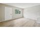 Inviting living room with hardwood floors, white door, and large window offering natural light at 12885 W Alameda Dr, Lakewood, CO 80228