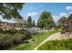 Scenic view of the community pool with lounging chairs surrounded by lush landscaping at 12885 W Alameda Dr, Lakewood, CO 80228