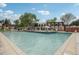 Beautiful pool with a tanning ledge and several chairs and umbrellas for relaxing by the water at 12885 W Alameda Dr, Lakewood, CO 80228