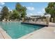 A swimming pool with plenty of space, tanning chairs, and a patio along the side for relaxation at 12885 W Alameda Dr, Lakewood, CO 80228