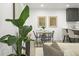 Open-concept dining area with modern table, stylish chairs, and sleek cabinets at 9340 Pierce St, Westminster, CO 80021