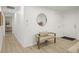 Bright hallway features neutral walls, a bench, a decorative mirror, and flows seamlessly into adjacent living spaces at 9340 Pierce St, Westminster, CO 80021