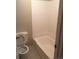 Simple bathroom featuring a toilet and a bathtub with white tile surround at 2281 S Vaughn Way # 118A, Aurora, CO 80014