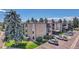 Apartment building complex featuring multiple floors, car parking, and lawns at 2281 S Vaughn Way # 118A, Aurora, CO 80014