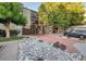 Apartment building exterior with stone landscaping and red brick walkway at 2281 S Vaughn Way # 118A, Aurora, CO 80014