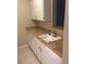 Compact kitchen features white cabinetry, a square sink, and laminate countertops at 2281 S Vaughn Way # 118A, Aurora, CO 80014