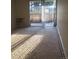 Living room featuring sliding glass door for natural light and outdoor access at 2281 S Vaughn Way # 118A, Aurora, CO 80014