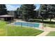 Community pool with wrought iron fence and mature shade trees at 2281 S Vaughn Way # 118A, Aurora, CO 80014