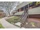 A multi-Gathering building with wood facade and siding, featuring private balconies and exterior staircases at 3050 W 32Nd Ave # 102C, Denver, CO 80211