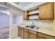Kitchen area showcasing wood cabinetry and a stainless steel sink at 3050 W 32Nd Ave # 102C, Denver, CO 80211