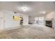 Living room with fireplace, sliding glass doors, and view into the kitchen at 3050 W 32Nd Ave # 102C, Denver, CO 80211