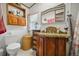 Bathroom with wood vanity, granite countertops, and a toilet at 422 Willow Dr, Lochbuie, CO 80603