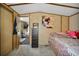 Bedroom with gray carpet, a bed, wood paneled walls, and a painting at 422 Willow Dr, Lochbuie, CO 80603