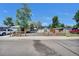 Charming single-story home with light blue siding, a spacious driveway, and attractive wooden fencing at 422 Willow Dr, Lochbuie, CO 80603