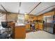 The kitchen features a breakfast bar, stainless steel appliances and wood cabinets at 422 Willow Dr, Lochbuie, CO 80603