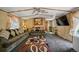 Comfortable living room featuring stylish furniture, ceiling fan and mounted television at 422 Willow Dr, Lochbuie, CO 80603