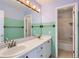 Bathroom featuring a double vanity, a large mirror, and a shower-tub combo at 17045 Hastings Ave, Parker, CO 80134