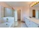 Bright bathroom with a soaking tub, shower, and double vanity with ample counter space at 17045 Hastings Ave, Parker, CO 80134