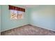 Comfortable bedroom with a bright window, plush carpet, and neutral tones at 17045 Hastings Ave, Parker, CO 80134