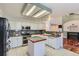 Well-lit kitchen with a central island, modern appliances, and white cabinets at 17045 Hastings Ave, Parker, CO 80134