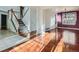 Bright living room featuring hardwood floors, staircase and abundant natural light at 17045 Hastings Ave, Parker, CO 80134